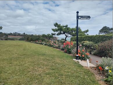 A signpost among flower beds in Dunmore East Park